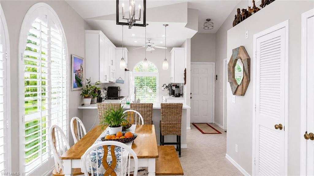 Kitchen featuring a white undermount sink, brushed nickel faucet, and light-colored countertops