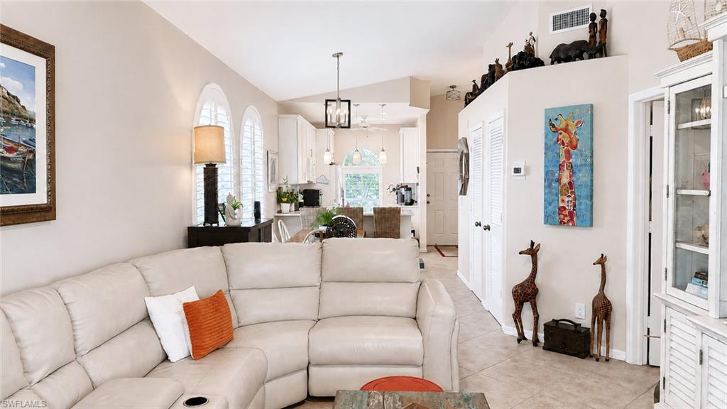 Vaulted ceiling with a ceiling fan, recessed lighting, and tile flooring