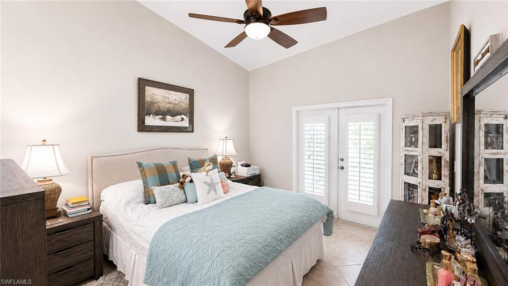 Vaulted ceiling, ceiling fan, wood-finish flooring, plantation shutters, and double doors