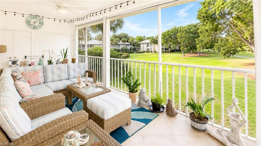 Screened lanai featuring expansive outdoor space, a ceiling fan, and bright natural light