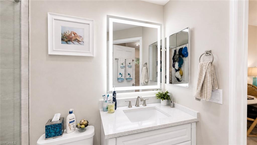Vanity with an integrated sink, quartz countertop, and brushed nickel faucet
