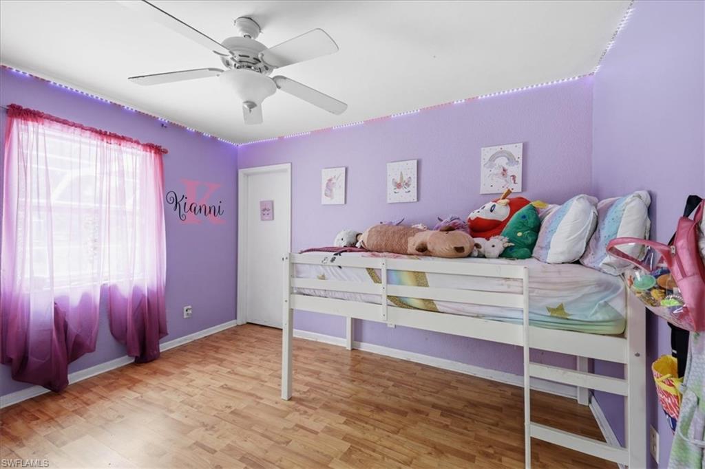 Light wood-finish flooring complements the room's purple walls
