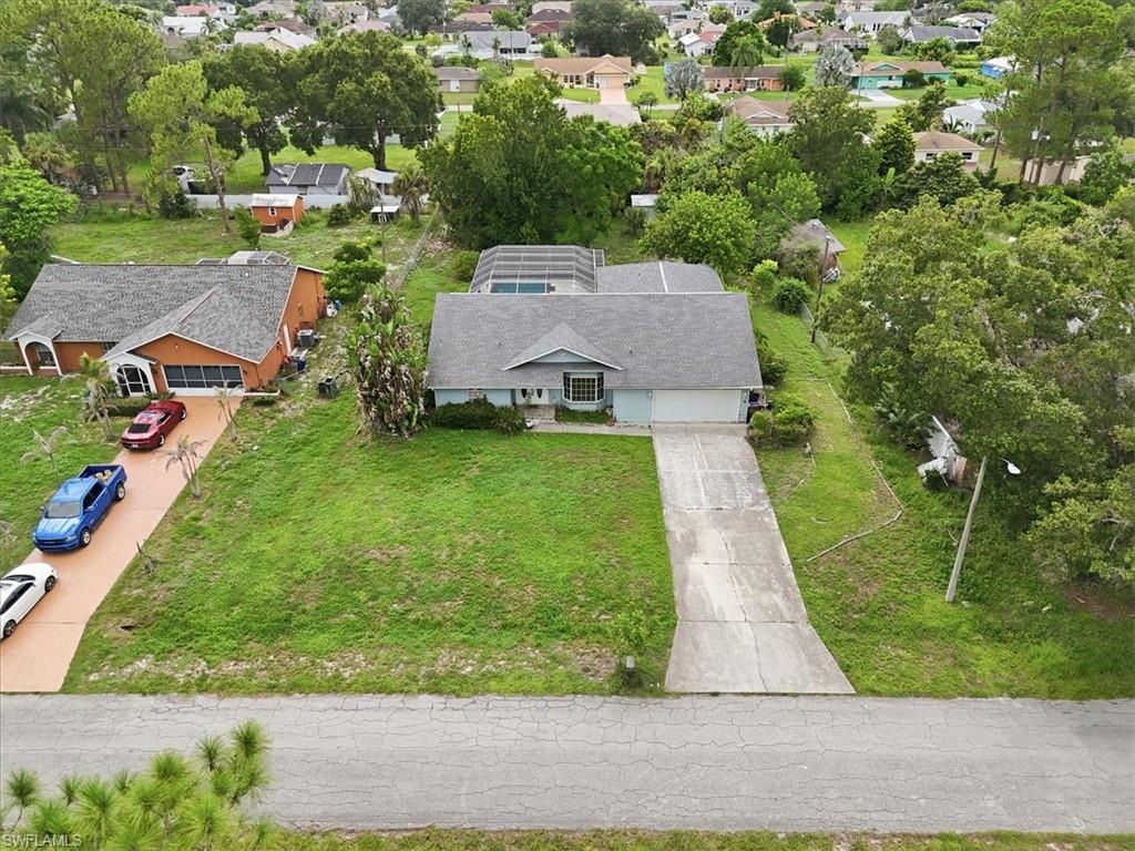 Single-story residence featuring a gray shingle roof, attached two-car garage, and a concrete driveway