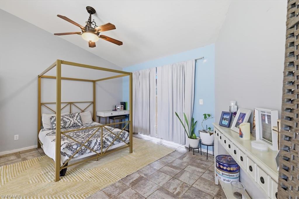 Vaulted ceiling featuring a ceiling fan with integrated lighting