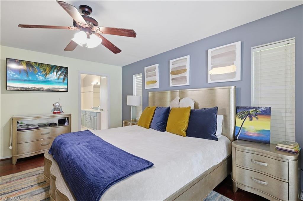 Bedroom featuring dark wood-finish flooring, a ceiling fan with integrated lighting, and a window with horizontal blinds