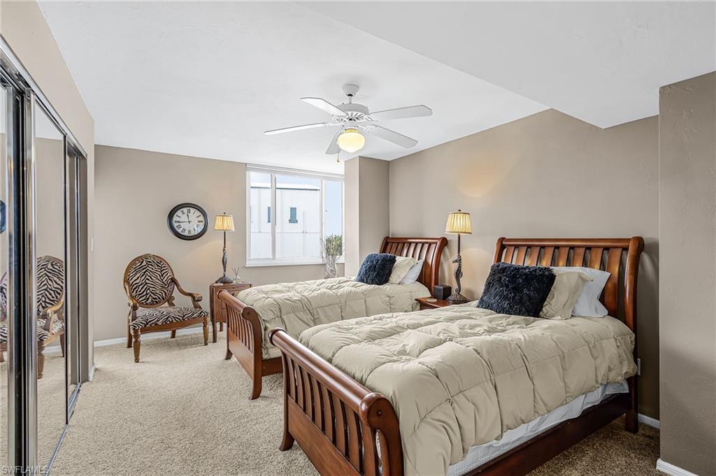 TWIN BEDS ADORN THE GUEST BEDROOM WHICH ALSO HAS ACCESS TO A SECOND SCREENED LANAI.