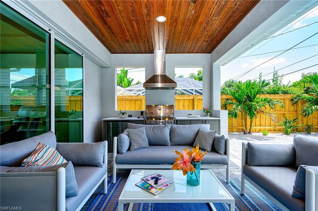 Covered Lanai with Outdoor Kitchen, Seating  and Wall Mounted TV