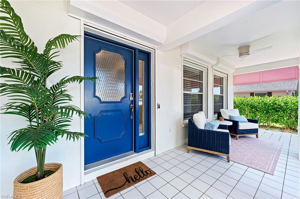 Property entrance with stucco siding and a patio