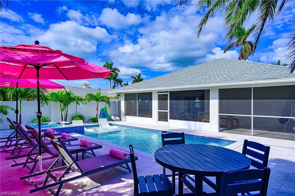 View of pool featuring a jacuzzi, a patio, and a sunroom