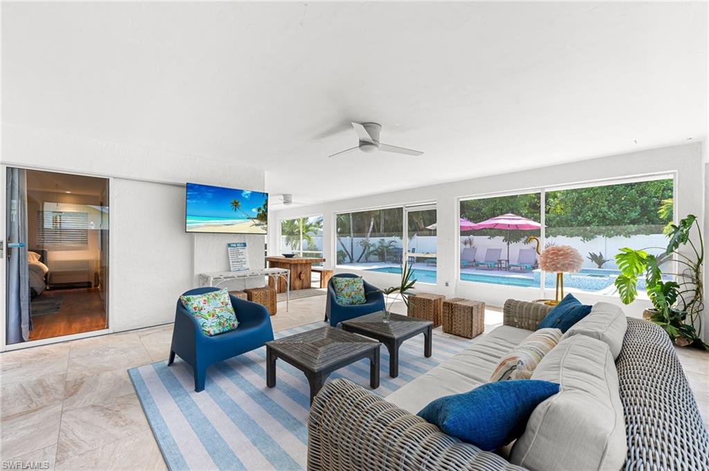 View of patio with outdoor lounge area and a ceiling fan