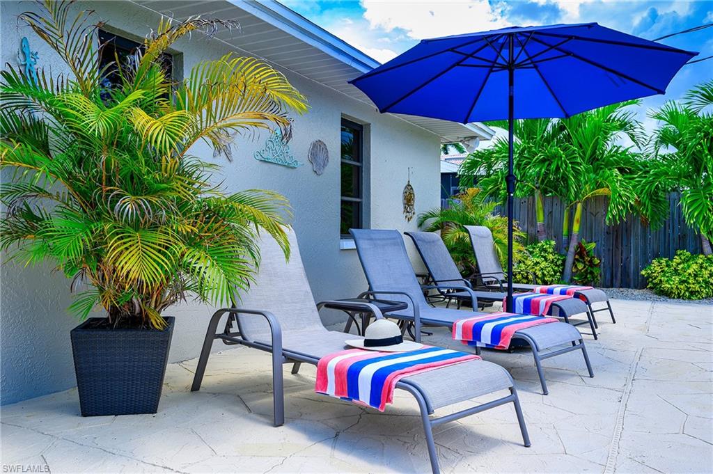 Generous Patio Surrounding Pool with 4 Chaise Lounges