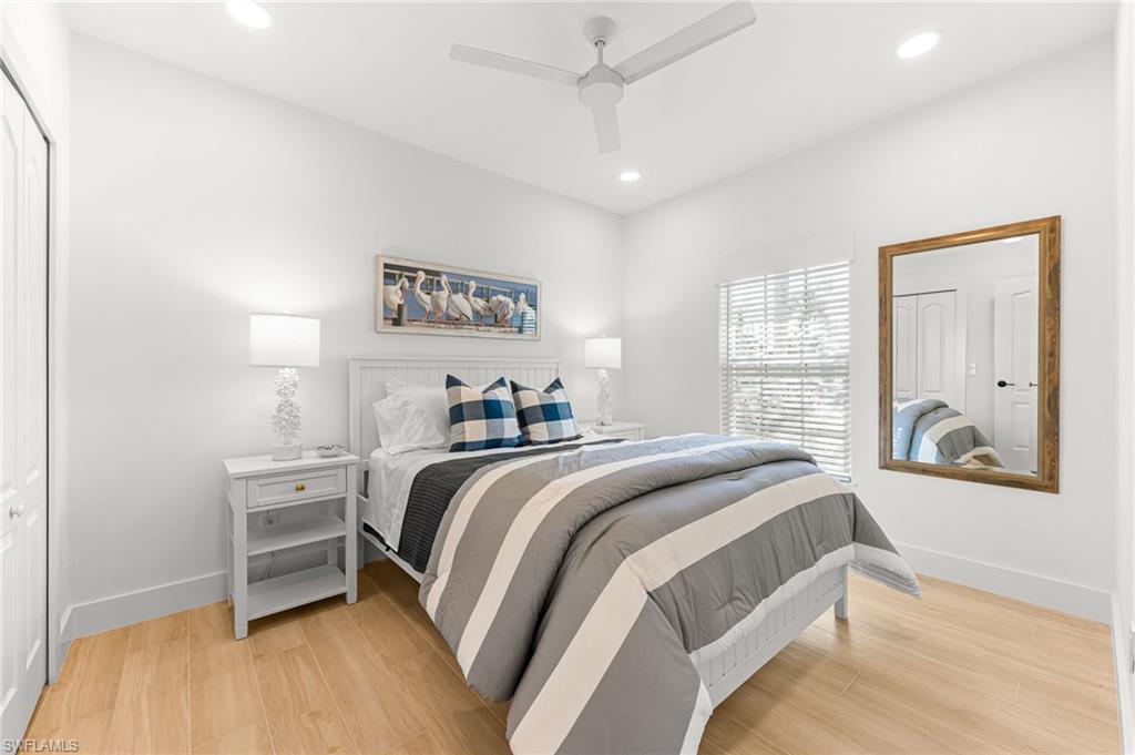Bedroom featuring light wood finished floors, recessed lighting, ceiling fan, and a closet