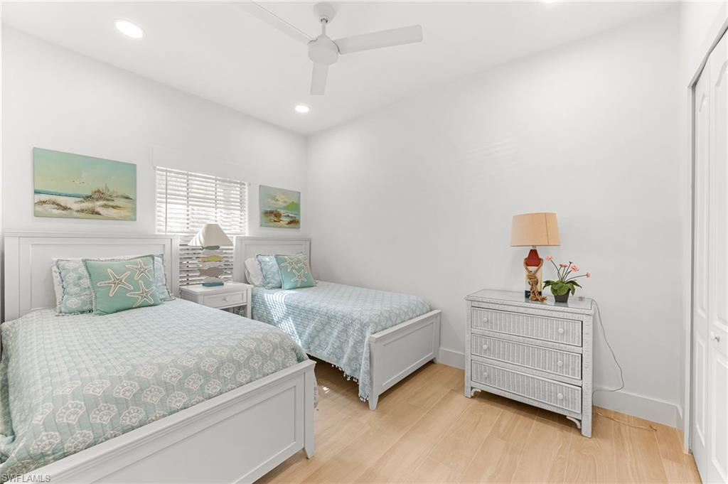 Bedroom with light wood-style floors, recessed lighting, a closet, and ceiling fan