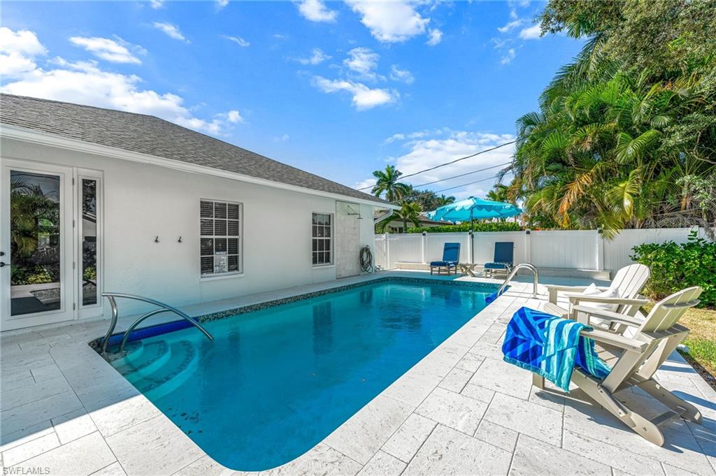 View of pool with a patio and a fenced backyard