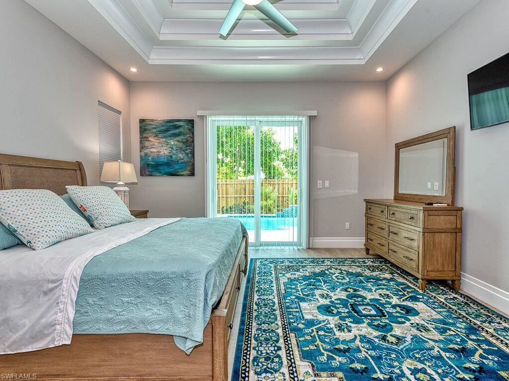 Main Bedroom with king size bed and access to pool area