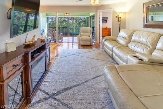 Wood-finish flooring leading to an outdoor balcony