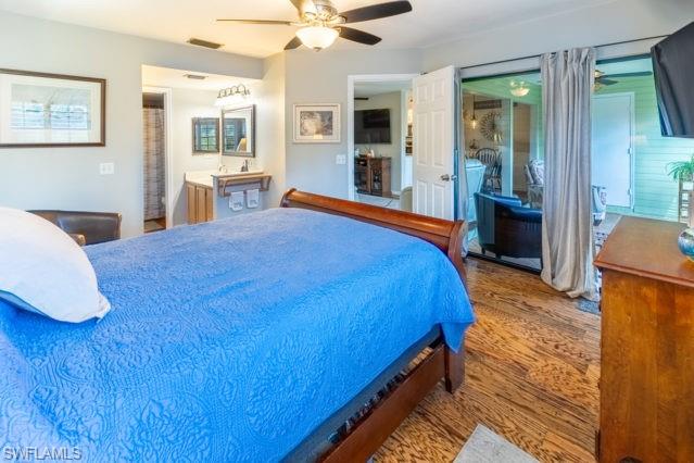 Wood-finish flooring throughout, ceiling fan, and direct access to an enclosed porch