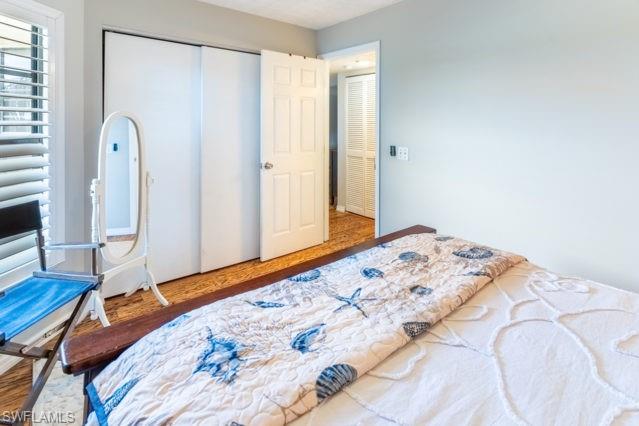 Wood-finish flooring throughout, complemented by a white paneled door and louvered window treatments