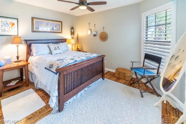 Wood-finish flooring, plantation shutters, and a ceiling fan