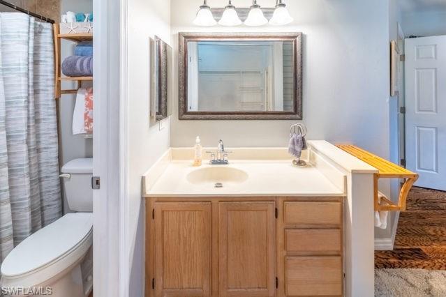 Vanity with a single sink, built-in cabinetry, and a framed mirror