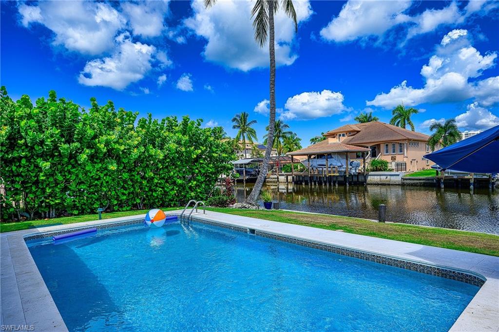 View of pool with a water view
