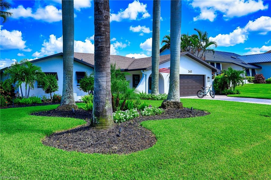 View of front of home featuring a garage and a front yard