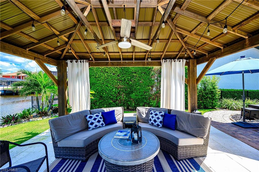 View of patio / terrace with ceiling fan, an outdoor living space, and a gazebo