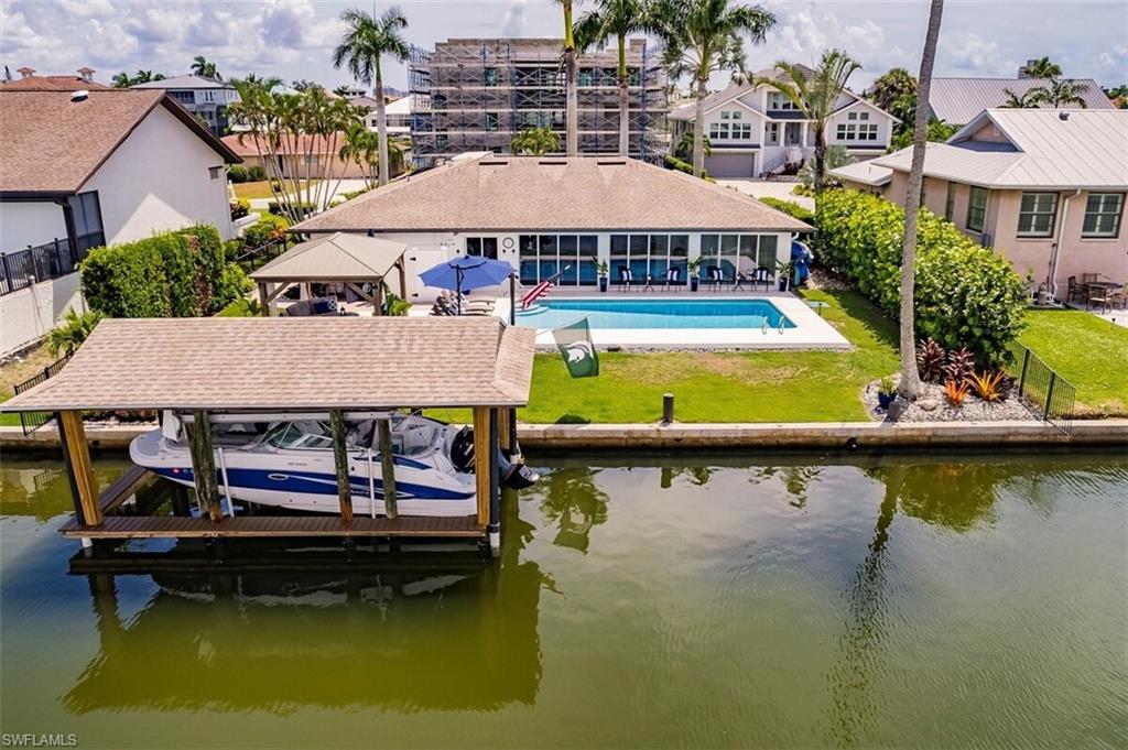 Dock area featuring a lawn, a patio, and a water view