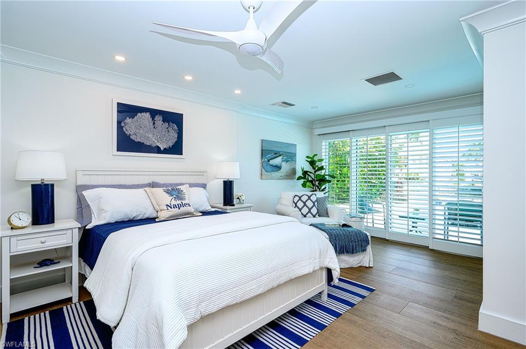 Bedroom featuring wood-type flooring, ceiling fan, access to outside, and crown molding
