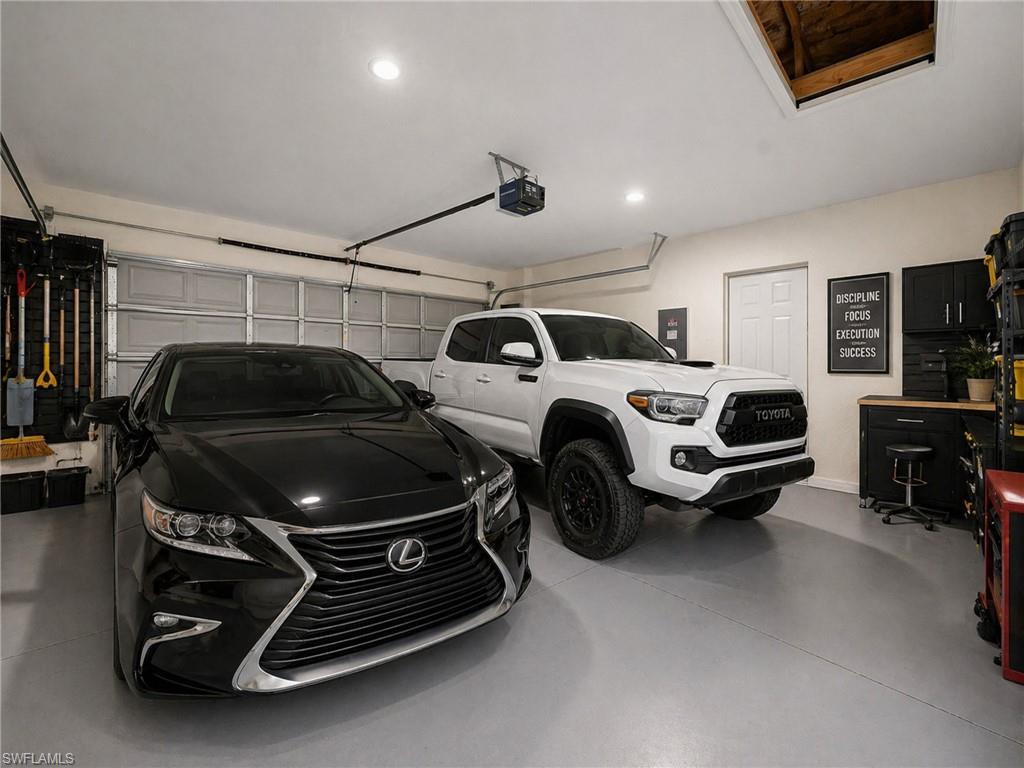AI: EXAMPLE: Spacious three-car garage featuring epoxy-coated flooring, recessed lighting, and wall-mounted storage systems
