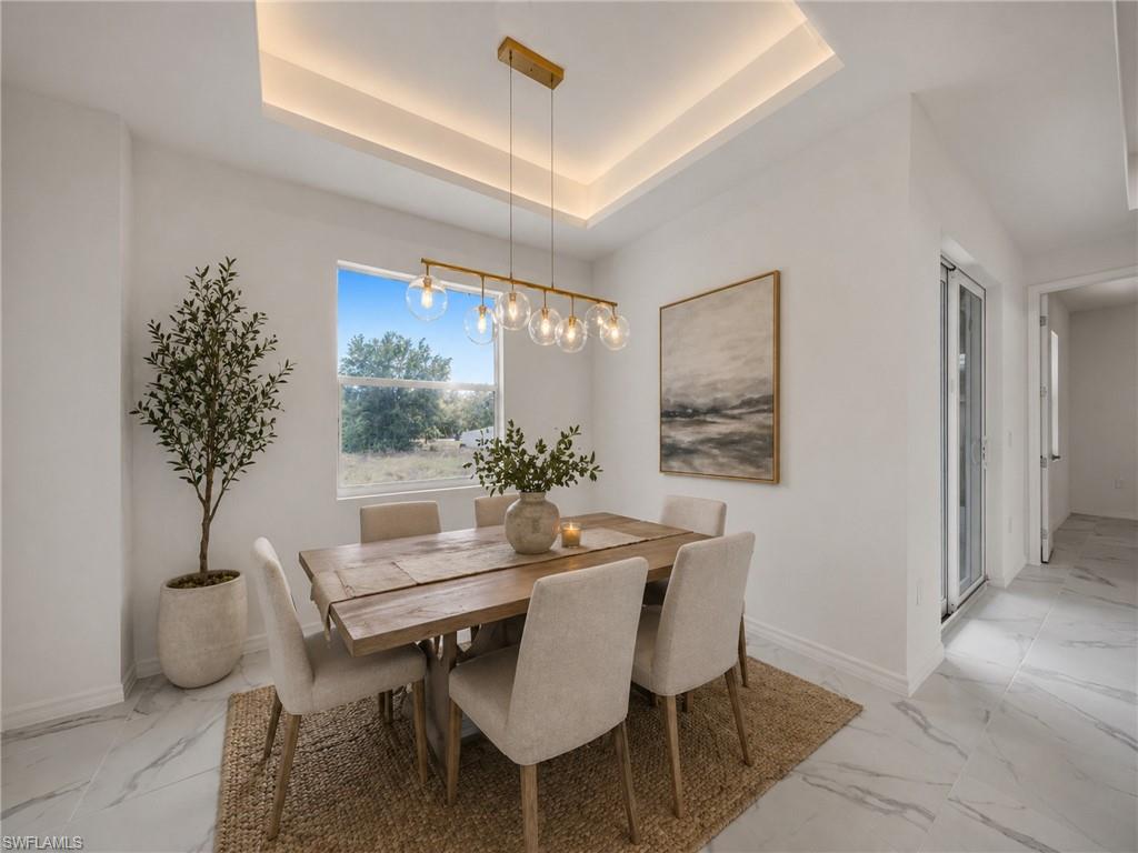 AI: Elegant dining space featuring a wood-finish table, upholstered dining chairs, and a linear pendant light fixture suspended from a coffered ceiling with integrated ambient lighting