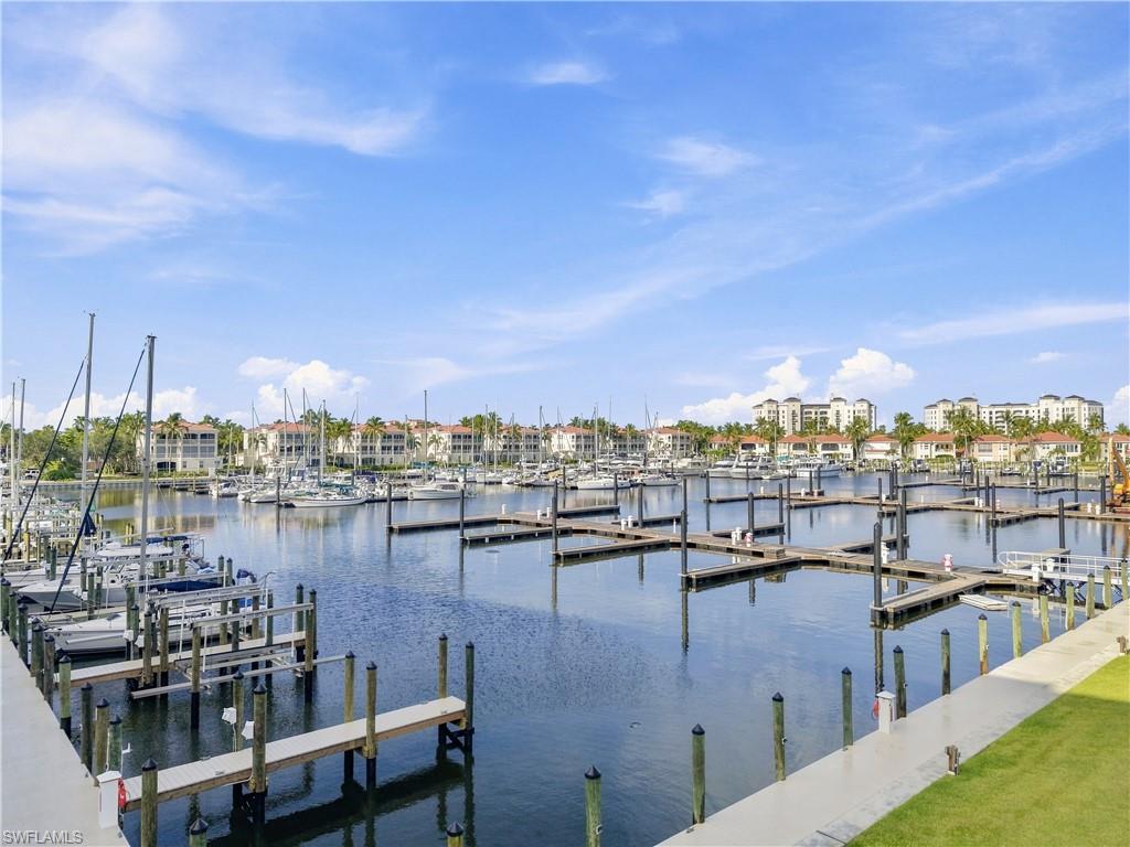 Marina setting featuring multiple boat slips, waterfront properties, and established landscaping