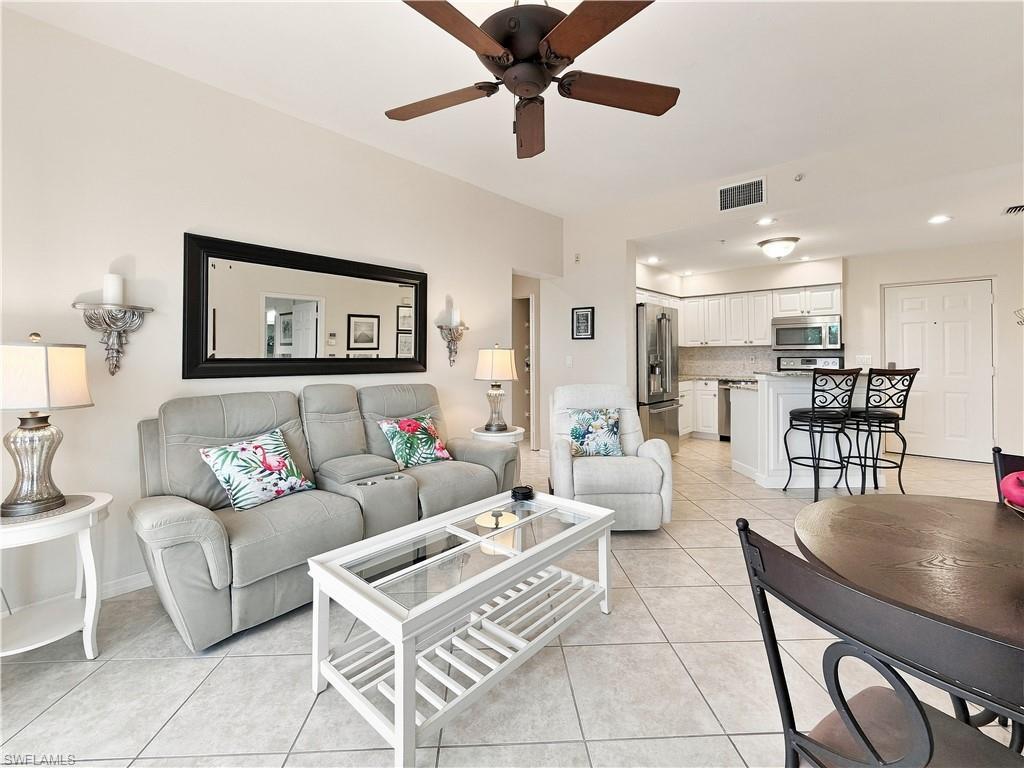 Recessed lighting, ceiling fan, tile flooring, white cabinetry, and stainless steel appliances