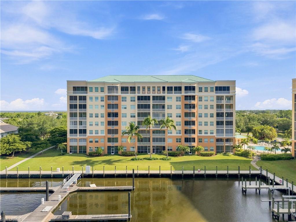Multi-story building with a green tile roof and private balconies