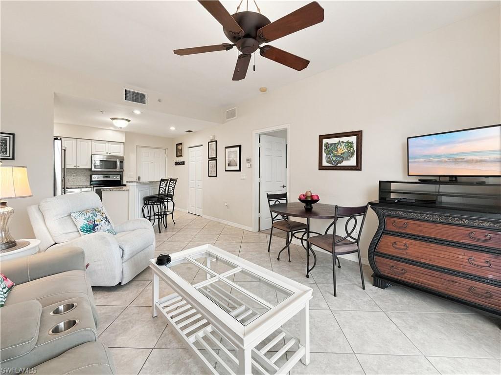 Open-concept living area with tiled flooring, vaulted ceiling with a ceiling fan, and recessed lighting