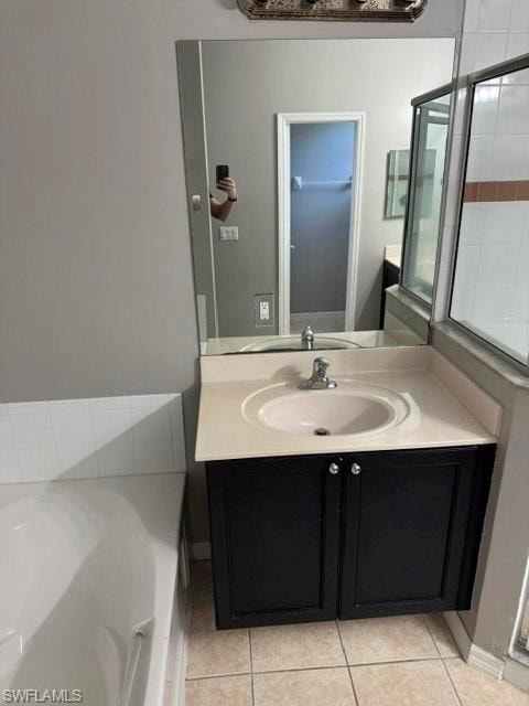 Bathroom with neutral tile flooring, a dark wood-finish vanity, a white integrated sink, and a framed shower enclosure