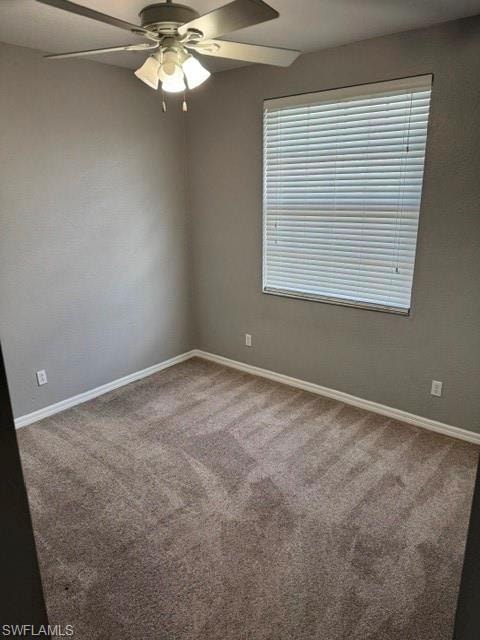 Recessed window with blinds, ceiling fan with integrated lighting, and neutral tone carpeting
