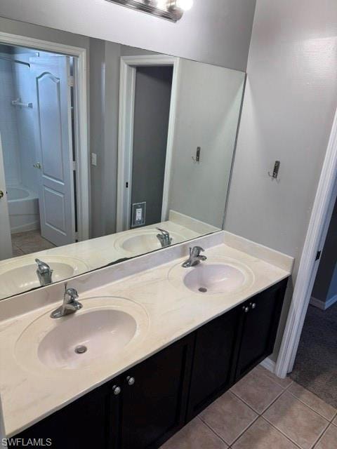 Dual vanity with integrated sinks, dark wood-finish cabinetry, and a chrome-finish light fixture