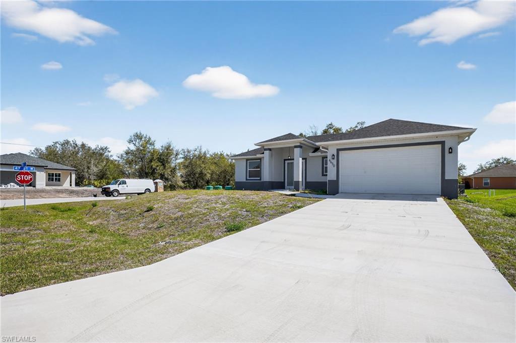 Contemporary single-story exterior with a two-tone facade, attached garage, concrete driveway, and dark shingle roof