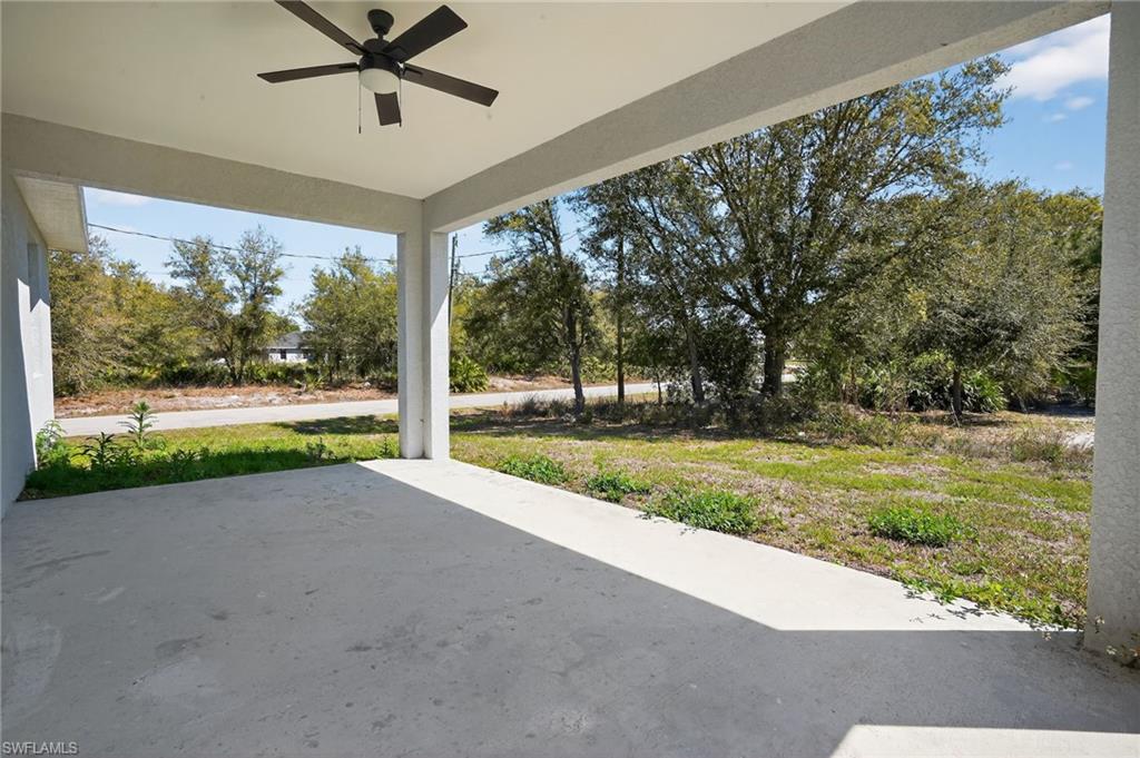 Covered concrete patio with an overhead ceiling fan