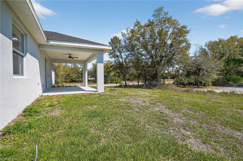 Concrete patio featuring a ceiling fan