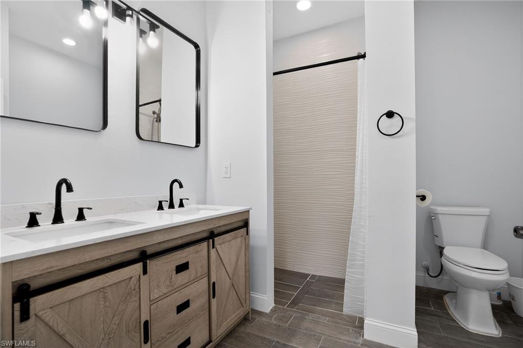 Dual vanity with white undermount sinks and matte black fixtures