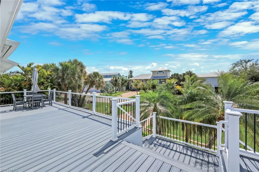 Expansive elevated deck with composite decking, white railing, and metal balusters