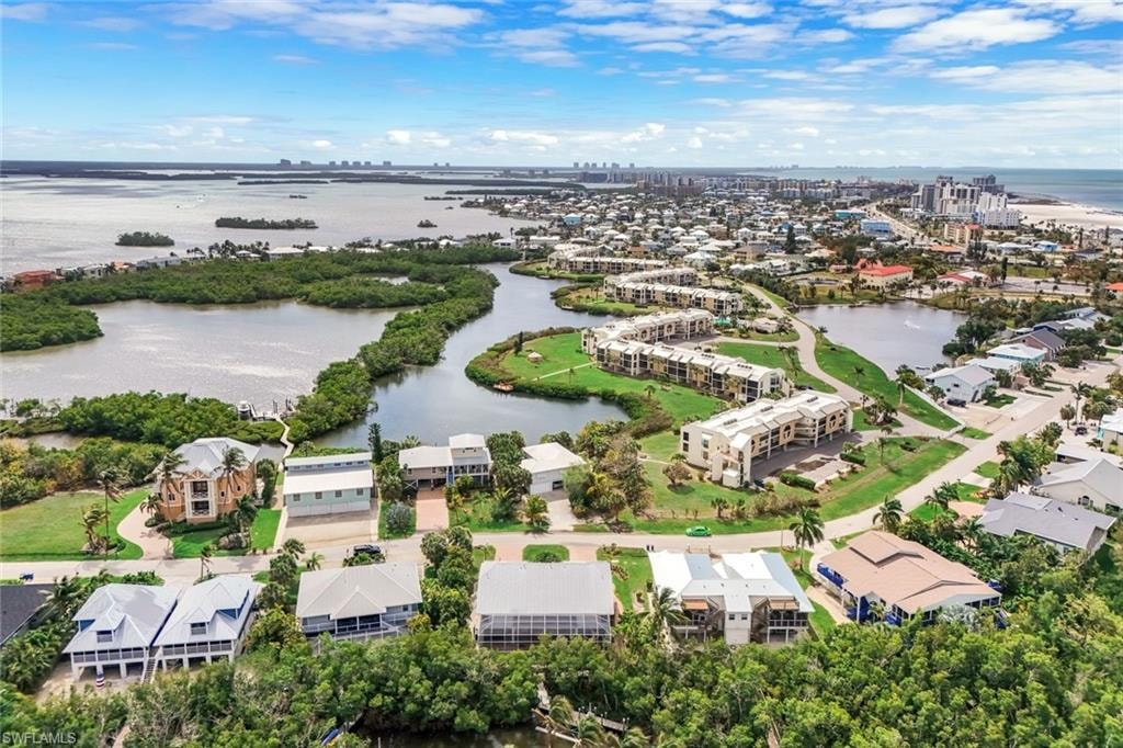 Coastal waters, abundant waterways, residential properties, urban development, and lush vegetation