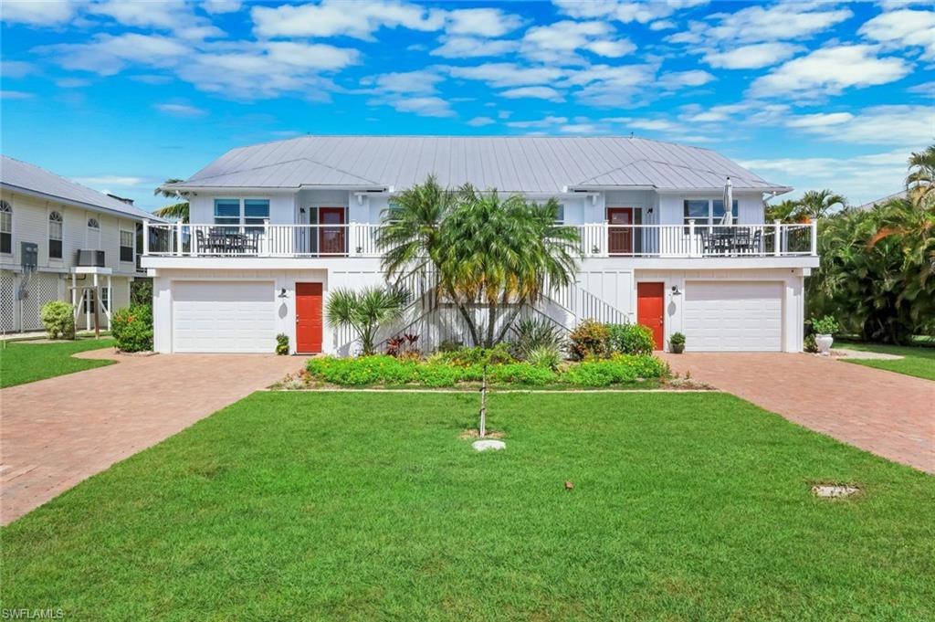 White exterior with a light gray metal roof