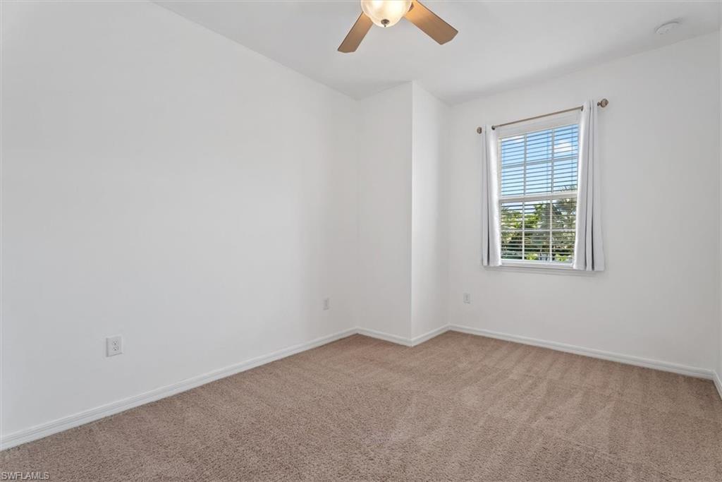 3rd Bedroom Neutral tone carpeting, white walls, window with blinds, ceiling fan with integrated lighting, and white trim