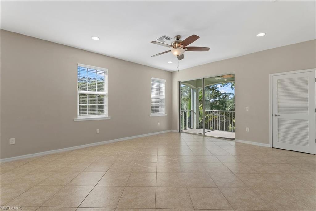 Spacious room with tiled flooring and light neutral walls