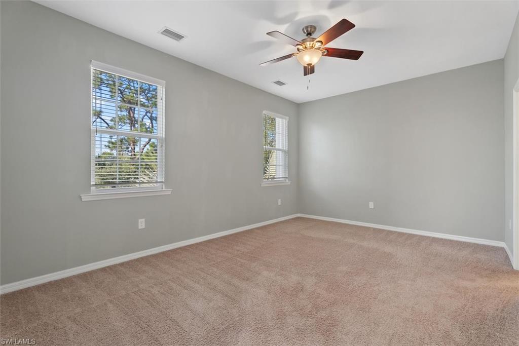 Primary bedroom Neutral-toned carpeting paired with light gray walls
