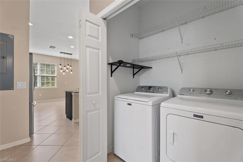 Laundry closet with wire shelving and a wall-mounted folding shelf