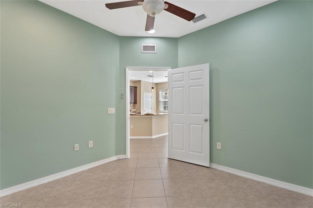 Den/Office Tile flooring and a ceiling fan with integrated lighting